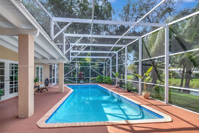 outdoor pool featuring french doors, a patio area, and a lanai