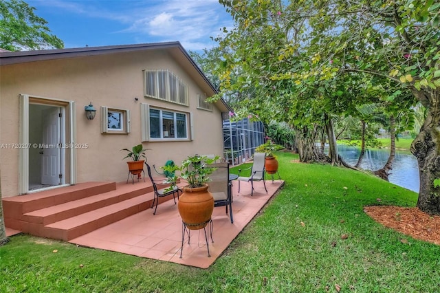 exterior space with a patio area and a water view