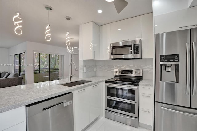 kitchen featuring modern cabinets, appliances with stainless steel finishes, white cabinets, and a sink