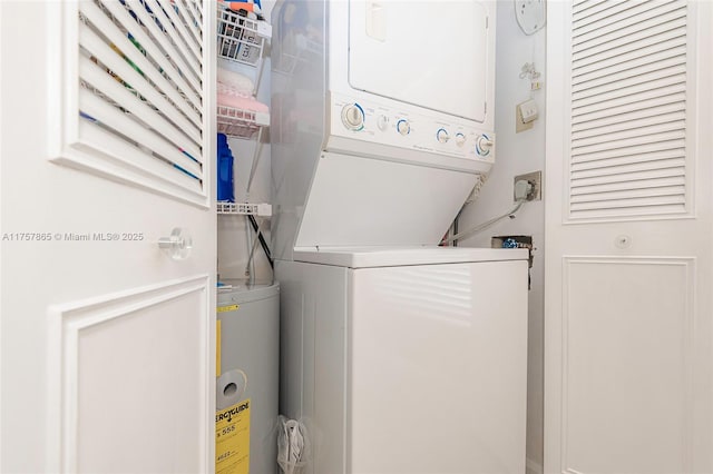 laundry room featuring stacked washer / drying machine and laundry area