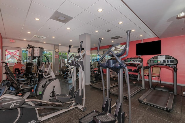 exercise room featuring a paneled ceiling, baseboards, and recessed lighting