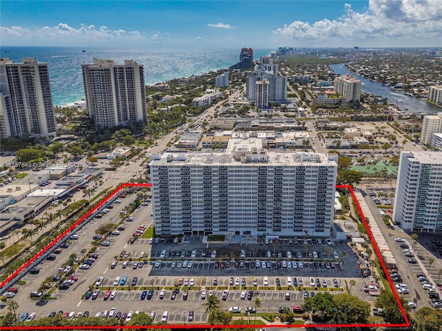 drone / aerial view with a city view and a water view