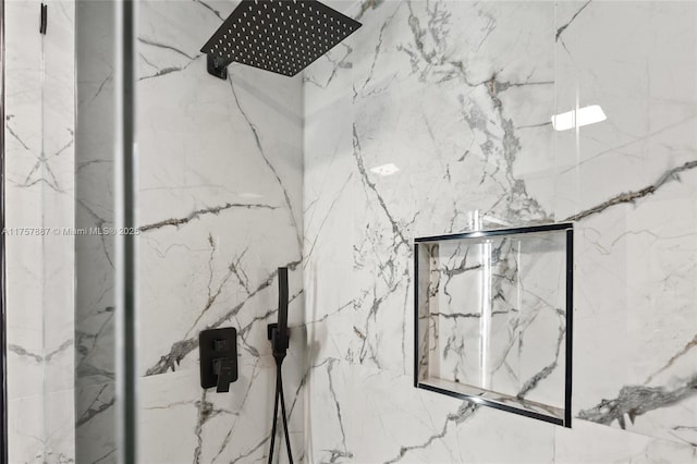 details featuring a marble finish shower