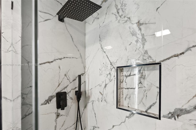 room details featuring a marble finish shower
