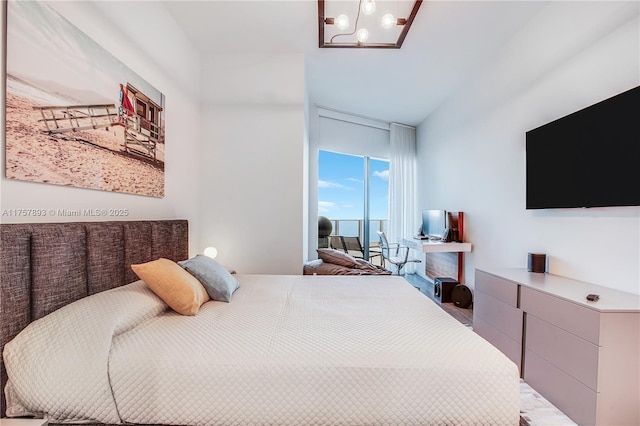 bedroom with floor to ceiling windows, access to exterior, and an inviting chandelier