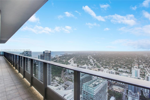 balcony with a water view and a city view