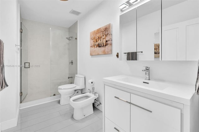 bathroom with visible vents, a shower stall, toilet, and a bidet