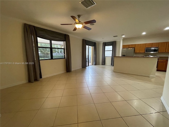 kitchen featuring brown cabinets, a healthy amount of sunlight, visible vents, and stainless steel appliances