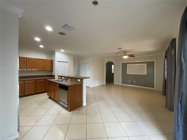 kitchen featuring visible vents, arched walkways, dishwasher, dark countertops, and a sink