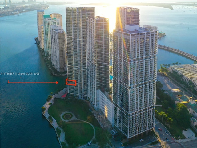 birds eye view of property with a water view and a city view