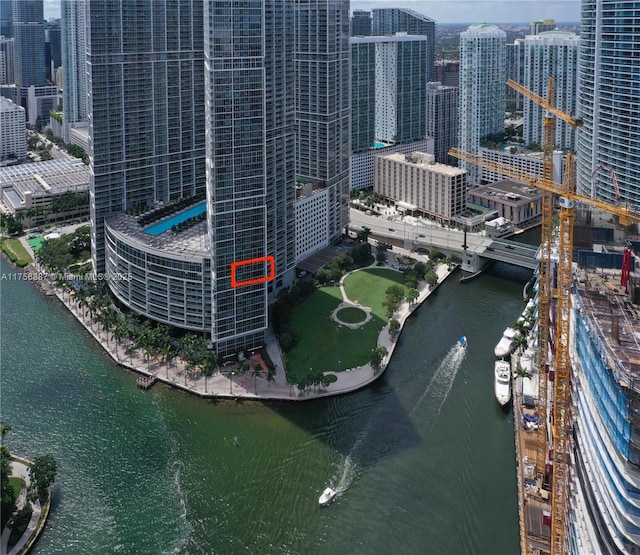 birds eye view of property featuring a water view and a city view