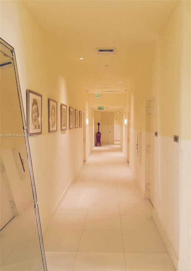 hall with light tile patterned floors and visible vents