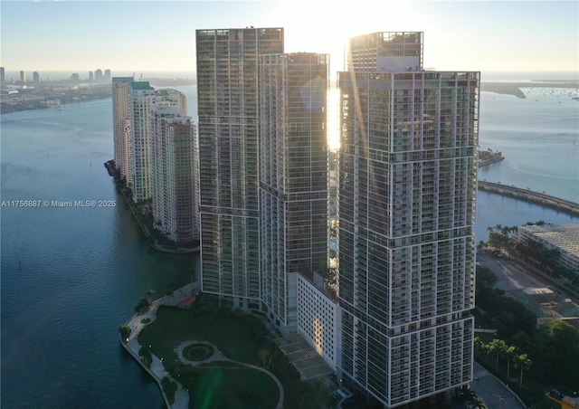 birds eye view of property with a water view and a city view