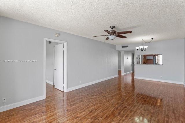 unfurnished living room featuring visible vents, a textured ceiling, wood finished floors, baseboards, and ceiling fan with notable chandelier