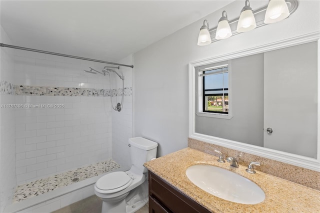 full bathroom with toilet, a shower stall, and vanity