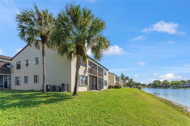 exterior space with central AC and a water view