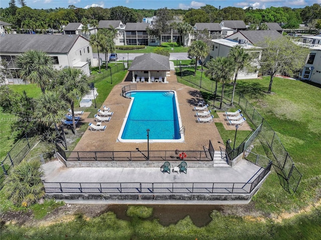 community pool with a yard, a residential view, fence, and a patio