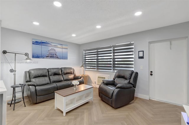 living room with recessed lighting, a wall unit AC, and baseboards