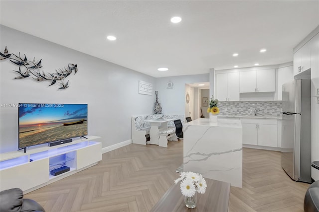 living room featuring baseboards and recessed lighting