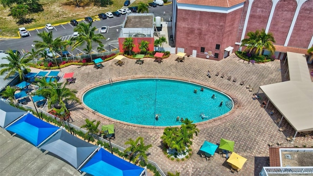 community pool featuring a patio and fence