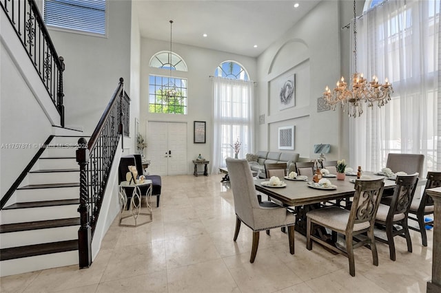 dining room with light tile patterned floors, recessed lighting, a high ceiling, stairway, and an inviting chandelier