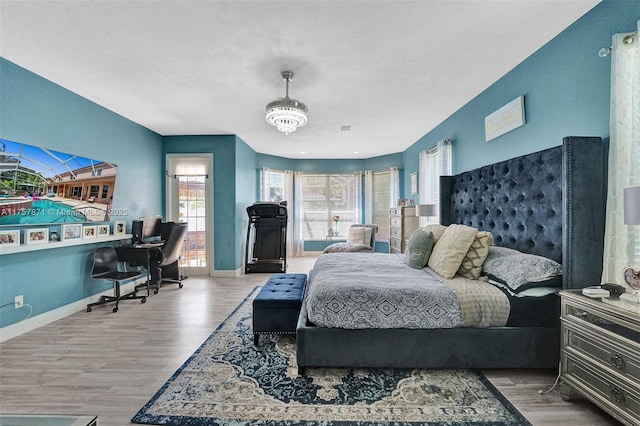 bedroom featuring baseboards and wood finished floors