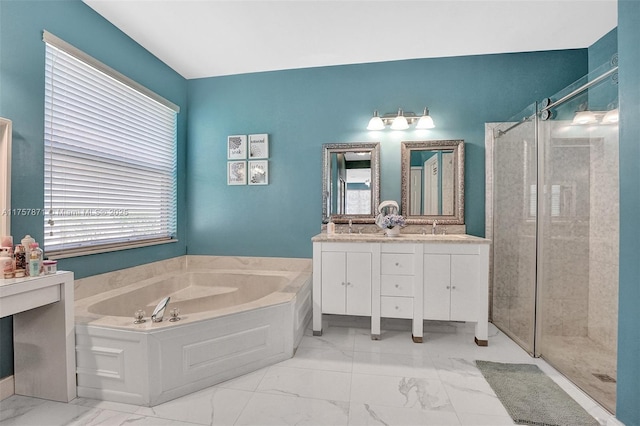 bathroom featuring marble finish floor, vanity, a shower stall, and a bath