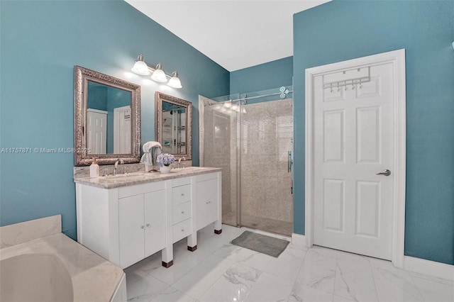 bathroom featuring marble finish floor, a sink, a shower stall, and double vanity