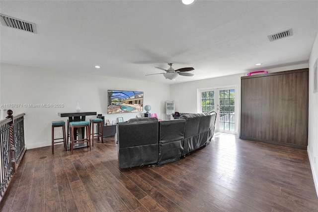 living area with dark wood-style floors, french doors, visible vents, and recessed lighting