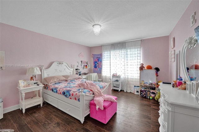 bedroom featuring a textured ceiling, visible vents, and hardwood / wood-style floors