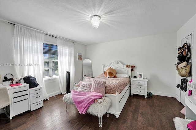 bedroom with wood finished floors and baseboards