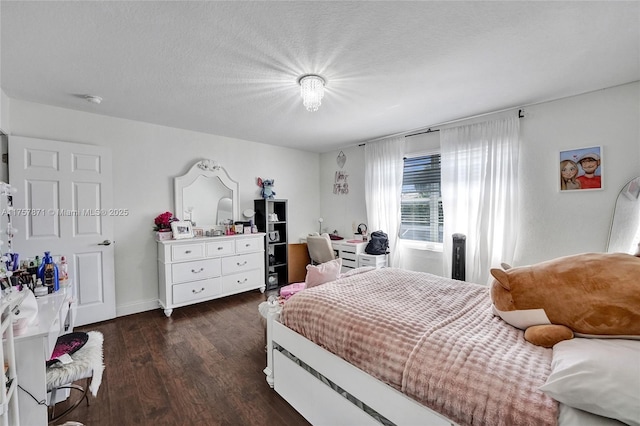 bedroom with dark wood-type flooring, a textured ceiling, and baseboards