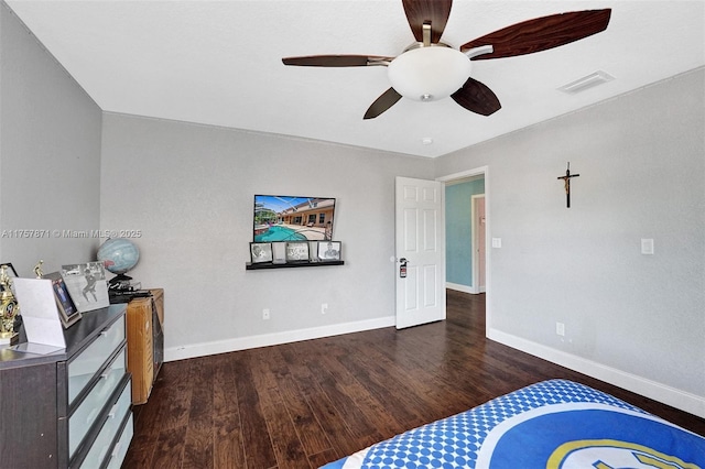 bedroom featuring a ceiling fan, wood finished floors, visible vents, and baseboards