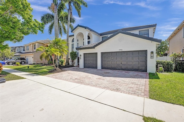 view of front of house with a front lawn, decorative driveway, and stucco siding