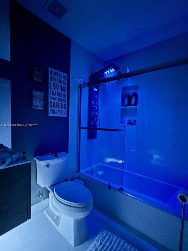 full bathroom with tile patterned flooring, combined bath / shower with glass door, toilet, and vanity