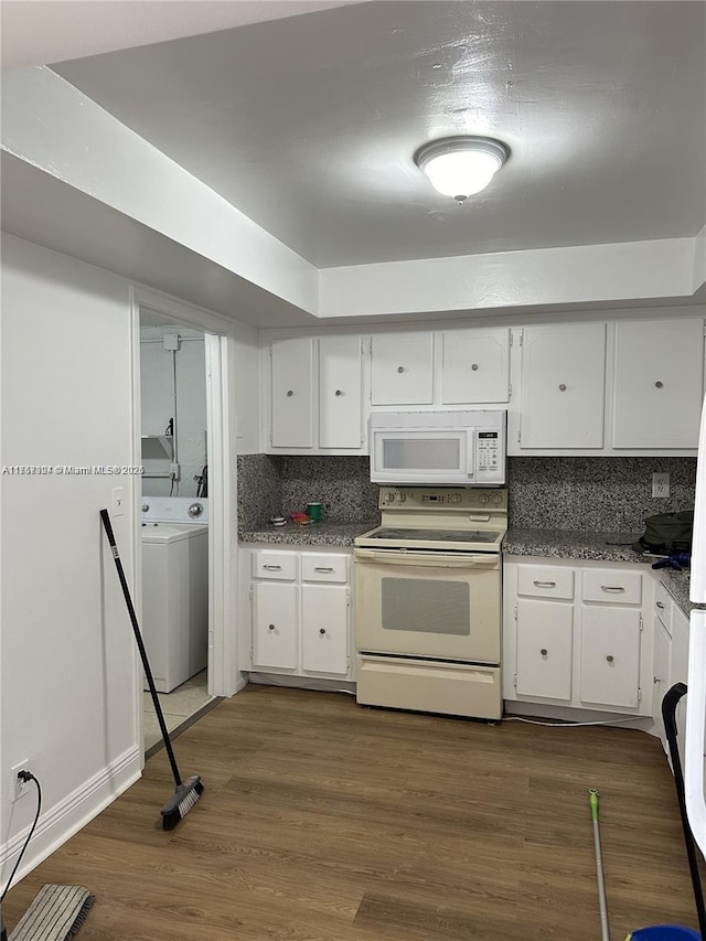 kitchen featuring decorative backsplash, white appliances, white cabinetry, and dark wood-style flooring