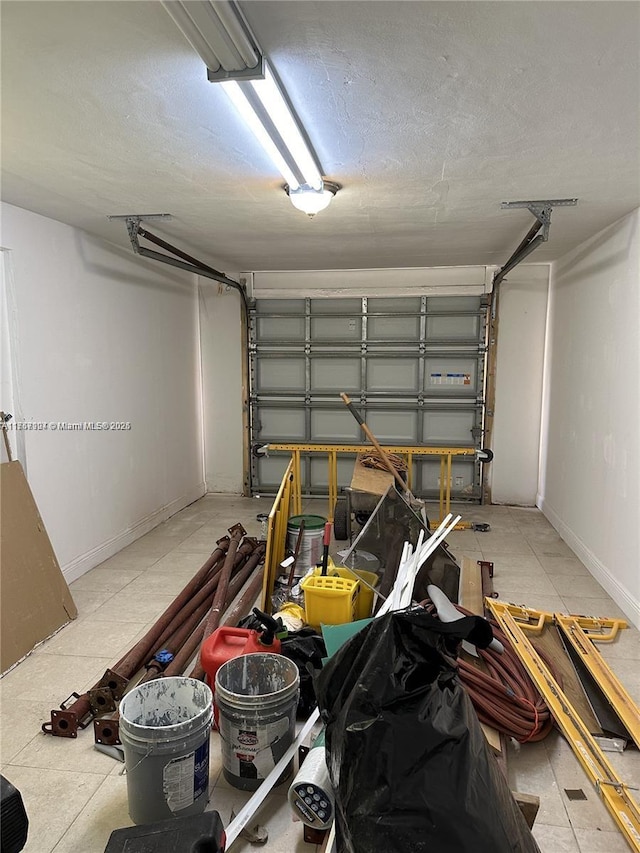 garage featuring baseboards and a garage door opener