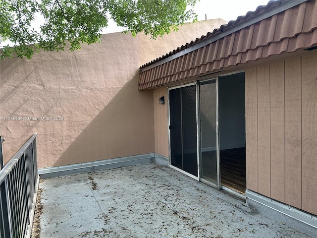 exterior space featuring a tiled roof