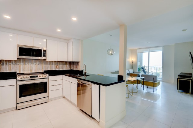1250 S Miami Ave Unit 1109, Miami, FL 33130 - kitchen with tasteful backsplash, appliances with stainless steel finishes, open floor plan, a sink, and modern cabinets