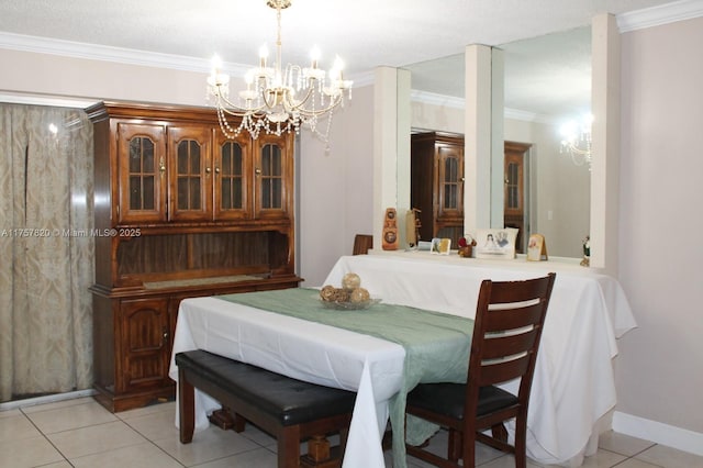 dining room with a chandelier, light tile patterned flooring, baseboards, and crown molding