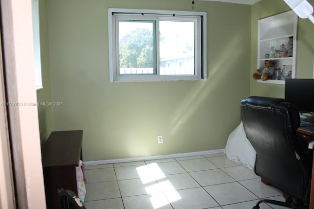 office area with baseboards and light tile patterned floors