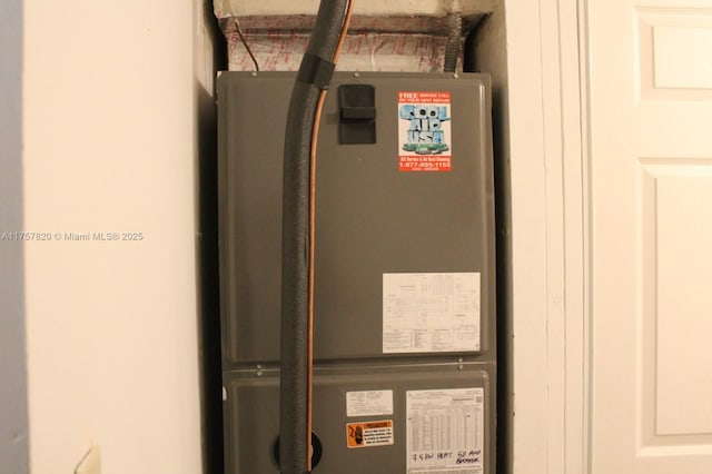 utility room featuring heating unit