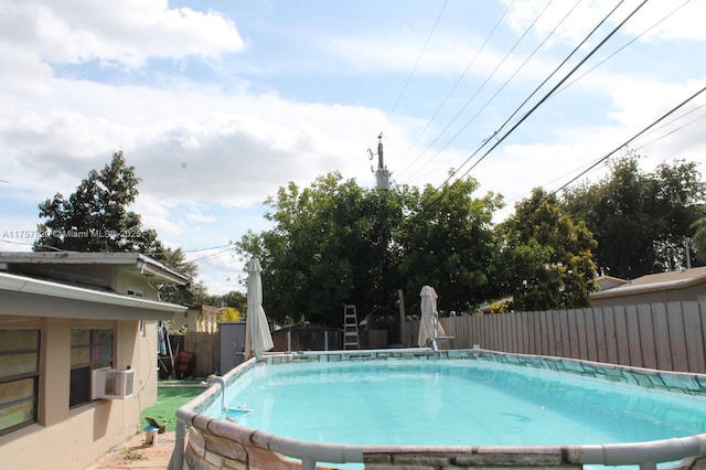 view of pool featuring cooling unit, fence, and a fenced in pool