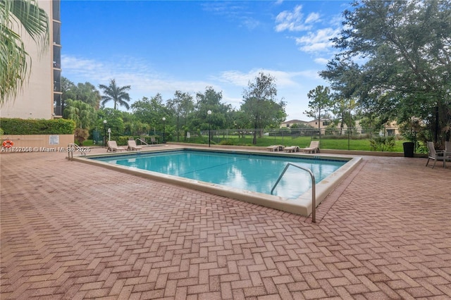 pool featuring a patio area and fence