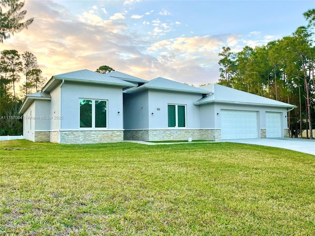 view of front of property featuring metal roof, stone siding, an attached garage, and stucco siding