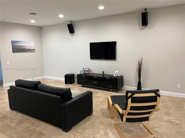 living area with stone finish flooring, visible vents, baseboards, and recessed lighting