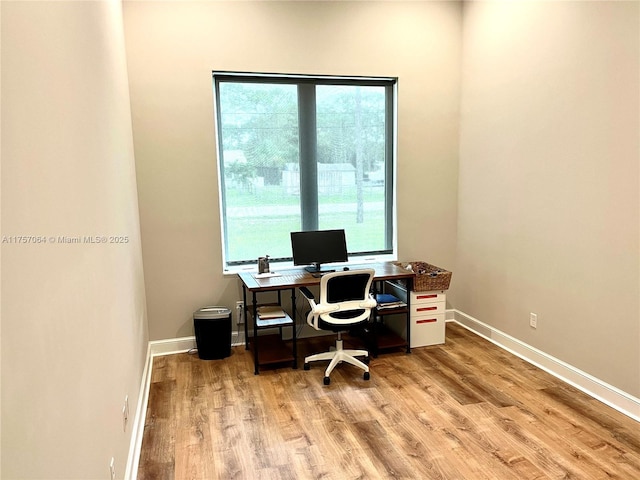 office space with light wood finished floors and baseboards