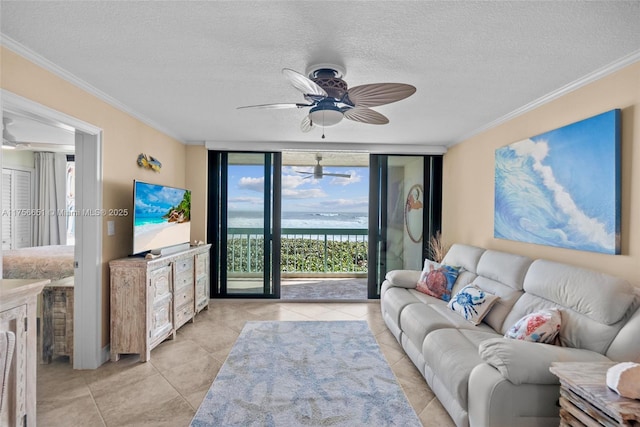 living area with expansive windows, light tile patterned floors, a textured ceiling, and crown molding