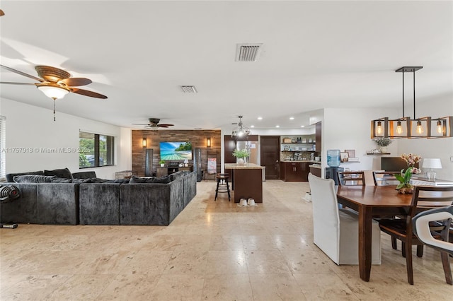 living area with ceiling fan, visible vents, and recessed lighting