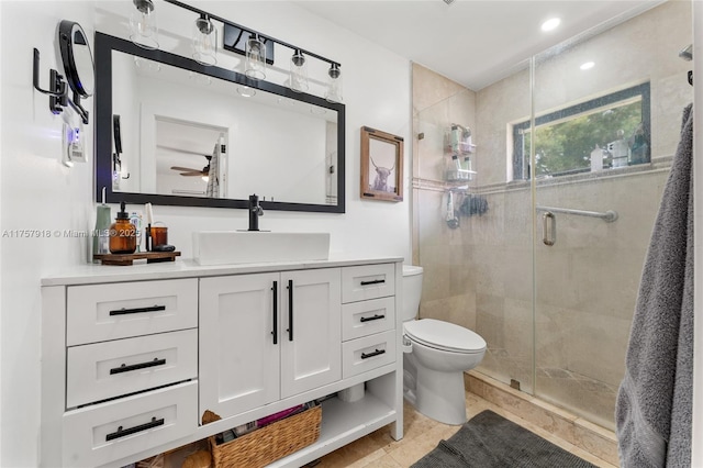 full bath featuring vanity, a shower stall, and toilet